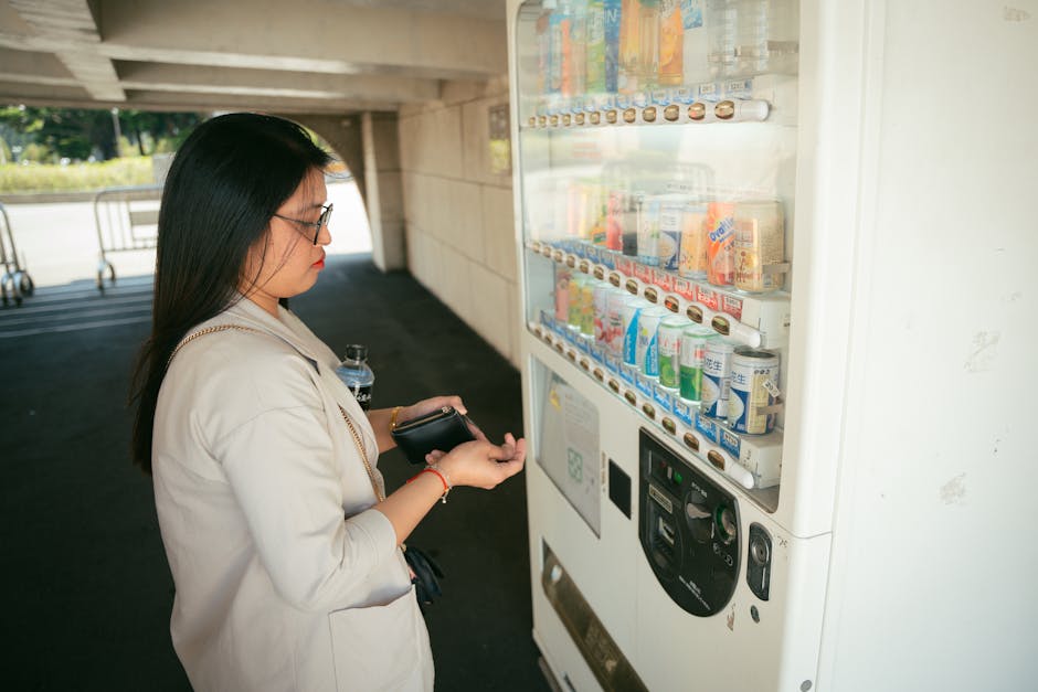 Woman interacts with a vending machine outdoors under a bridge in Taiwan.