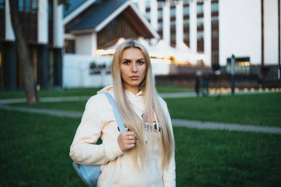 Portrait of a young woman standing in an urban park in Minsk, Belarus.