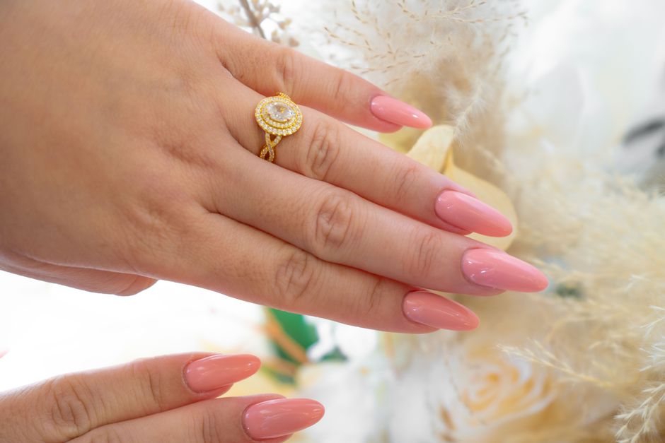 Close-up of a polished manicure and gold ring at a salon in Dubai, UAE.