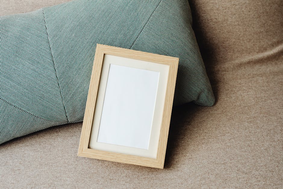 Minimalist image of a wooden frame and textured pillow on a sofa, ideal for mockups.