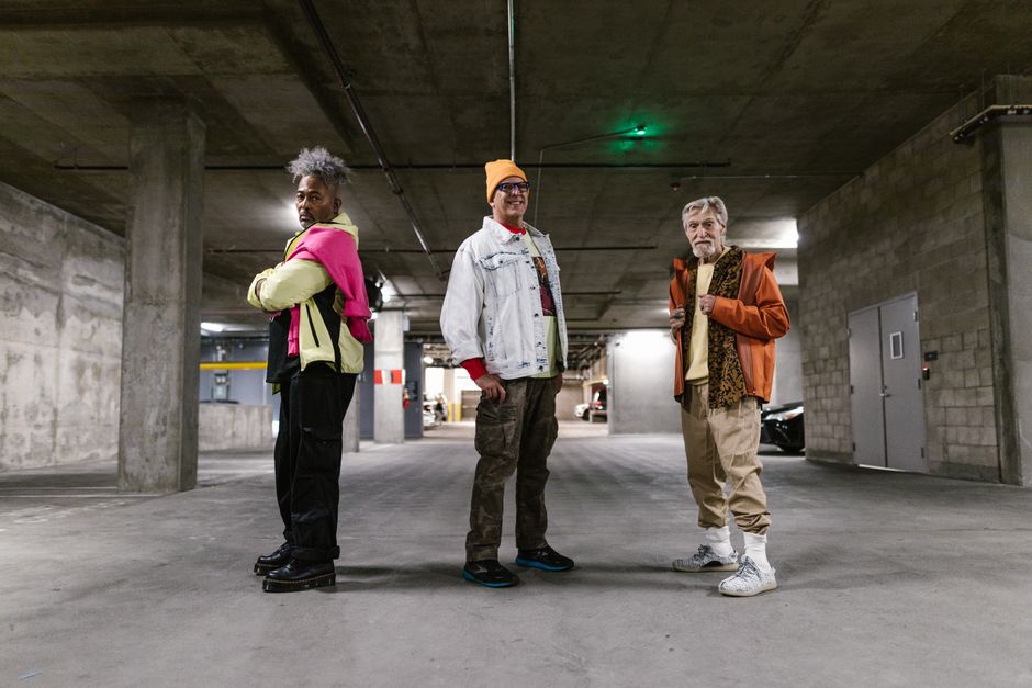 Elderly men showcasing fashionable street style outfits in an industrial setting.